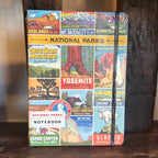 National Parks Vintage Notebook Large with a colorful collage cover of park posters secured by a black elastic band