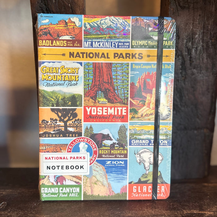 National Parks Vintage Notebook Large with a colorful collage cover of park posters secured by a black elastic band