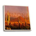 Coaster showing a desert scene with tall saguaro cacti at sunset and ARIZONA in orange