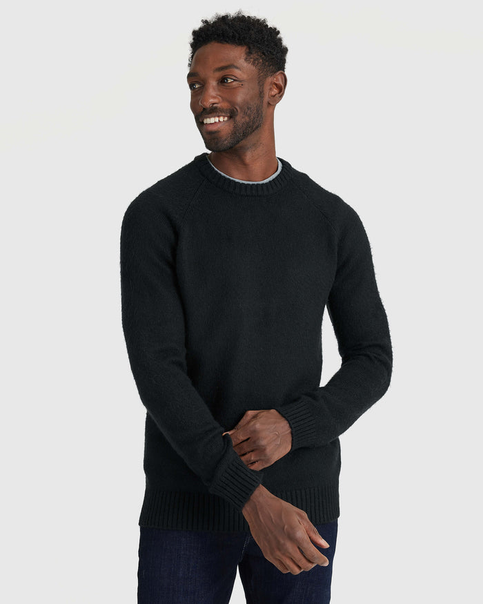 Man wearing Black Crew Neck Sweater, highlighting fit and ribbed details.