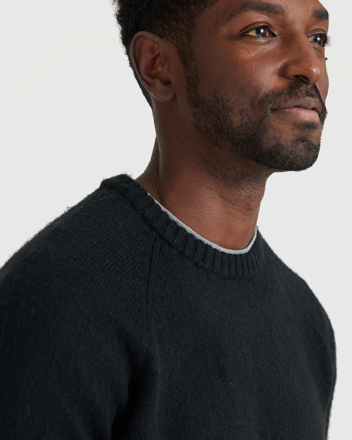 Black Crew Neck Sweater with ribbed neckline and textured knit detail.