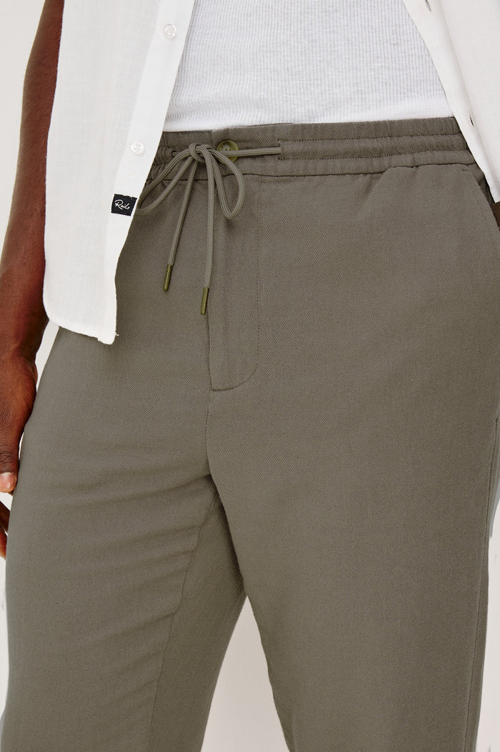Callum Tapered Straight Leg Pant in Linen Twill With Adjustable Drawstring Waistband Ties in Fallen Rock Colorway - Lower Body Front Cloes Up View Featured on Model