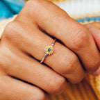 Side view of sunflower ring on finger showing orange enamel petals