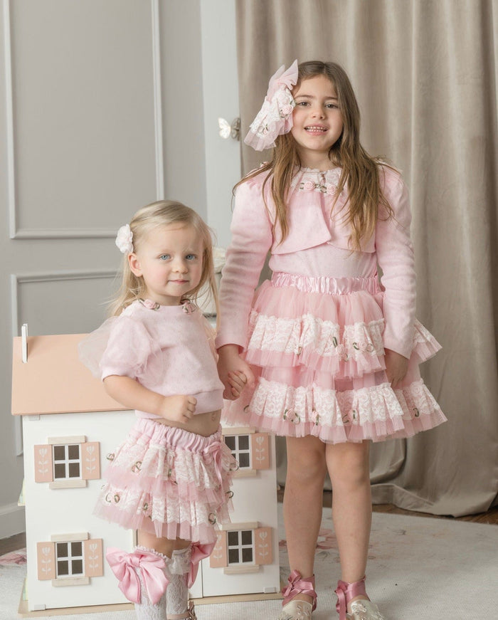 Girls wearing pink embroidered top with lace details