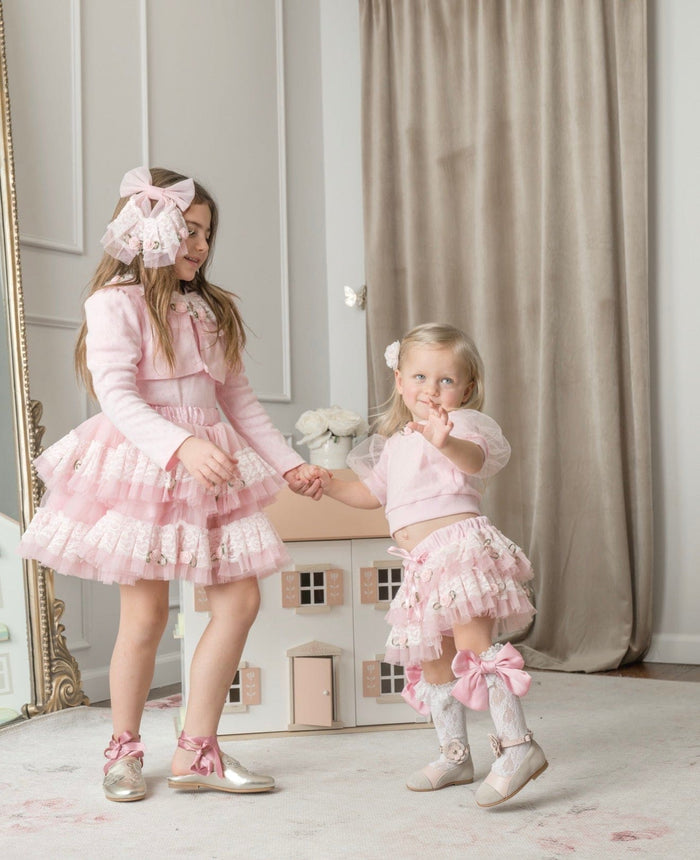 Girls wearing pink embroidered top with lace details