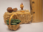 Haybale with Chicken and Cucumbers in Woven Basket