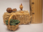 Haybale with Chicken and Cucumbers in Woven Basket