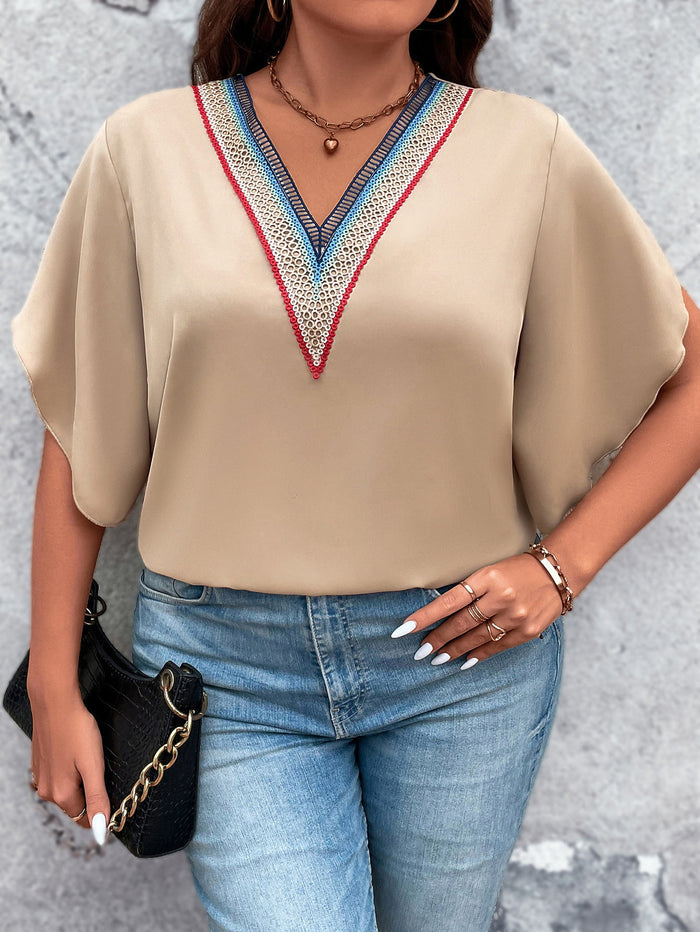 Trendsi plus size v-neck blouse in beige with colorful embroidery worn with blue jeans and accessories