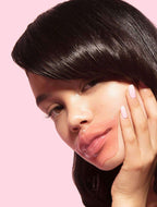 Close-up of a woman applying a Hydrating Reusable Lip Mask | Dreambox Beauty on her lips, showcasing smooth, moisturized skin and self-care in skincare routine.