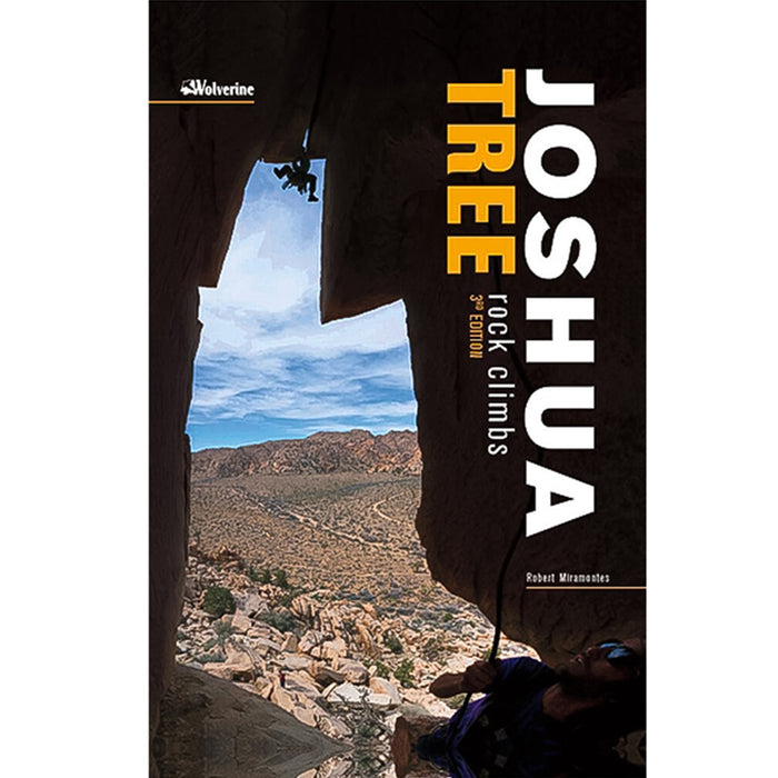 Joshua Tree Rock Climbs 3rd Edition guidebook cover featuring a climber framed by a desert rock archway.