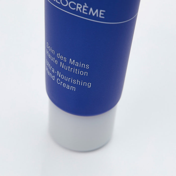 Close-up of a blue and white tube of Olécrème Hand Cream | Phytomer, labeled as ultra-nourishing skincare for hands, against a white background.