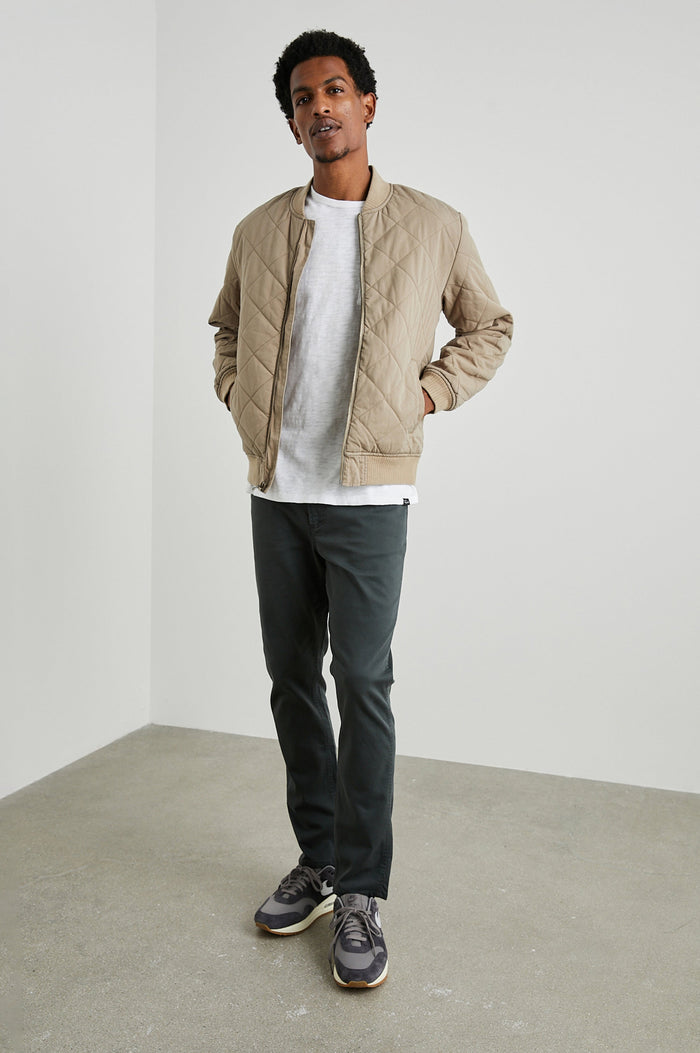 Peninsula Jacket with Zip Closure, Two Front Pockets, an Inner Zippered Pocket, a Quilted Pattern and Ribbed Trim in Vintage Khaki Colorway - Front Full Body View Featured on Model