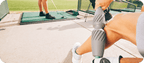 A person using the RAD Muscle Flushing Kit | RAD recovery tool on their calf outdoors, demonstrating its use in muscle care and wellness.