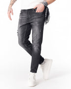 Martin Valen washed black slim-fit jeans side view showing ripped knee details and white sneakers partly visible