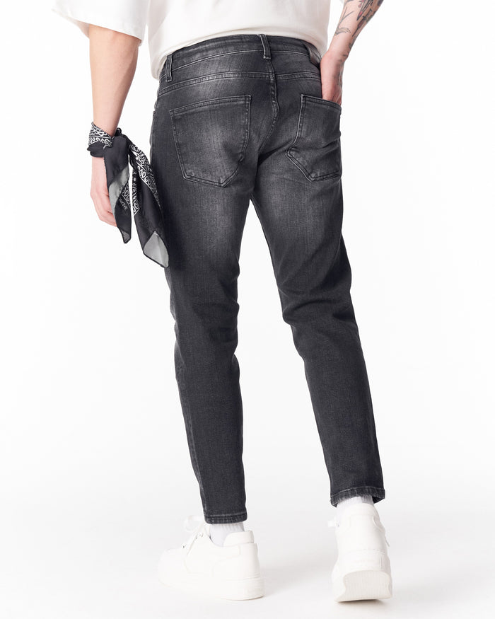 Martin Valen washed black slim-fit jeans rear view with back pockets and bandana on wrist