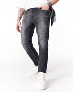 Martin Valen washed black slim-fit jeans full rear view with cropped hem and white sneakers