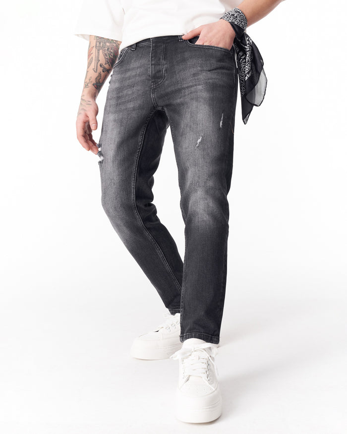 Martin Valen washed black slim-fit jeans full rear view with cropped hem and white sneakers