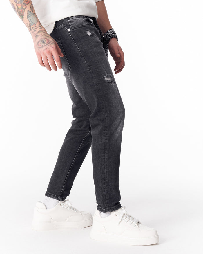 Martin Valen washed black slim-fit jeans front waist view with small thigh rips and bandana tucked in pocket