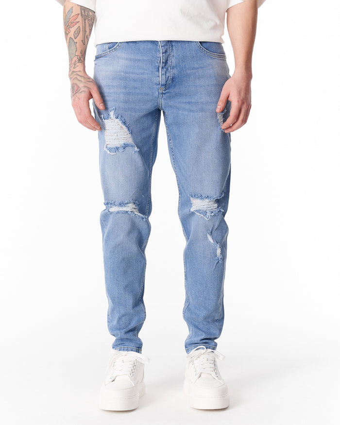 Martin Valen ripped slim-fit jeans in washed blue, front waist and knee rips visible