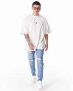 Martin Valen washed blue ripped slim-fit jeans, front view walking pose, distressed knee rips