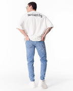 Martin Valen washed blue ripped slim-fit jeans, rear view with hands in pockets, back pockets and slim cut shown