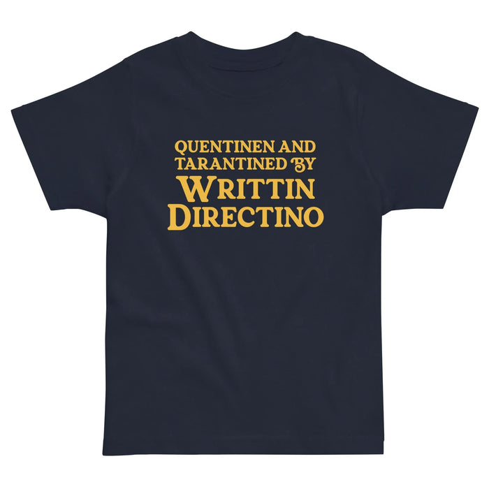 Writtin Directino Kid's Tee - The iconic heavy-serif typeface rendered in "retro popcorn gold (#F0B83C)" against a deep "midnight obsidian base (#0D0D0D)," instantly recalling the opening title cards of 1990s crime thrillers.